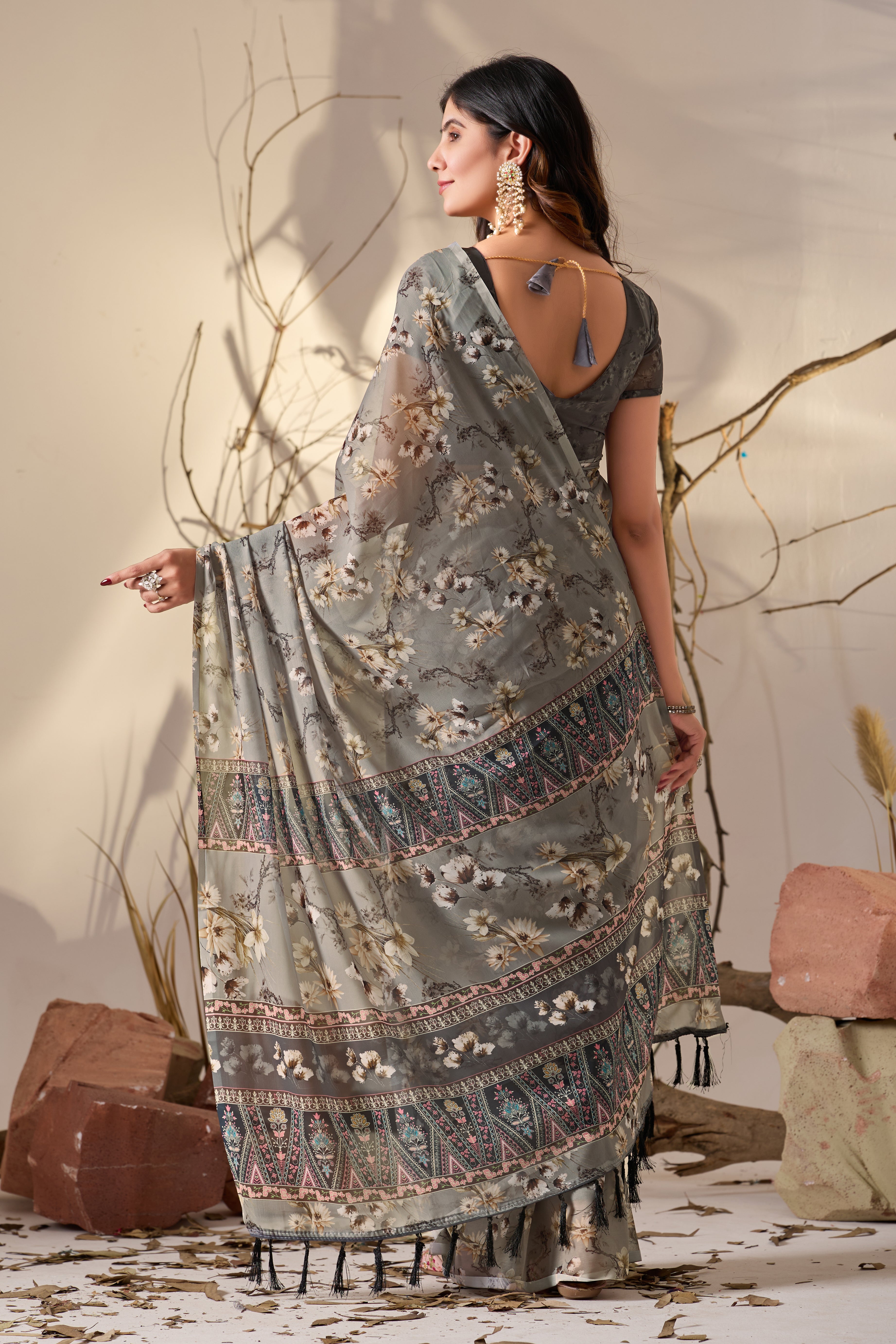 Soft Georgette Saree in Muted Grey Base Adorned with All-Over Floral Digital Print and Enhanced with Ornate Tribal-Style Patterned Pallu Featuring Pink