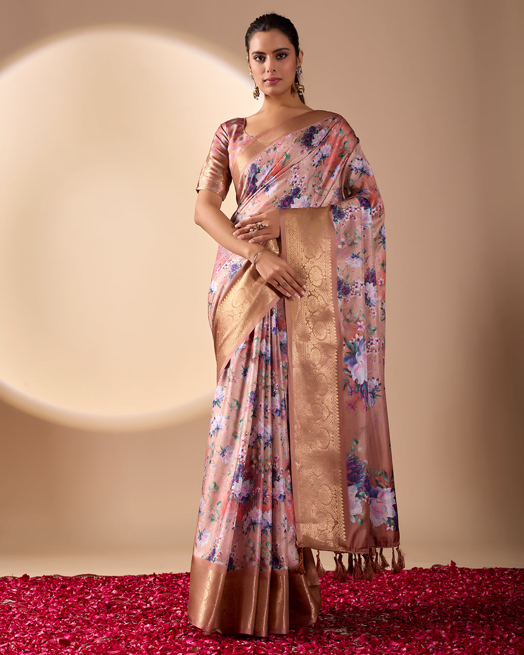 Soft Lichi Silk Saree in Rose Gold Shade enriched with elegant all-over floral digital prints and complemented by a luxurious woven zari border