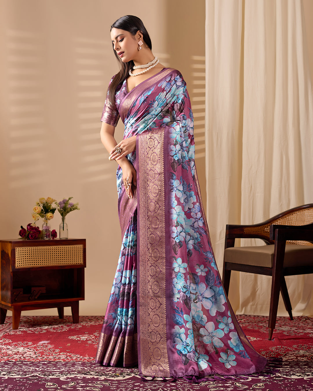 Soft Lichi Silk Saree beautifully enhanced with large blooming floral prints and a rich zari woven border