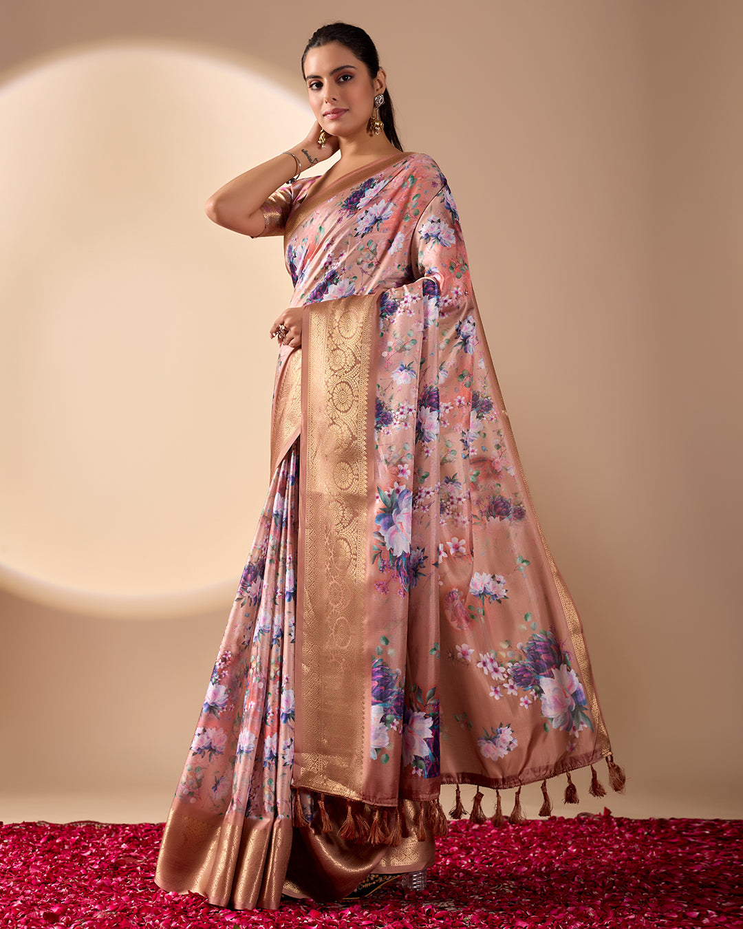 Soft Lichi Silk Saree in Rose Gold Shade enriched with elegant all-over floral digital prints and complemented by a luxurious woven zari border