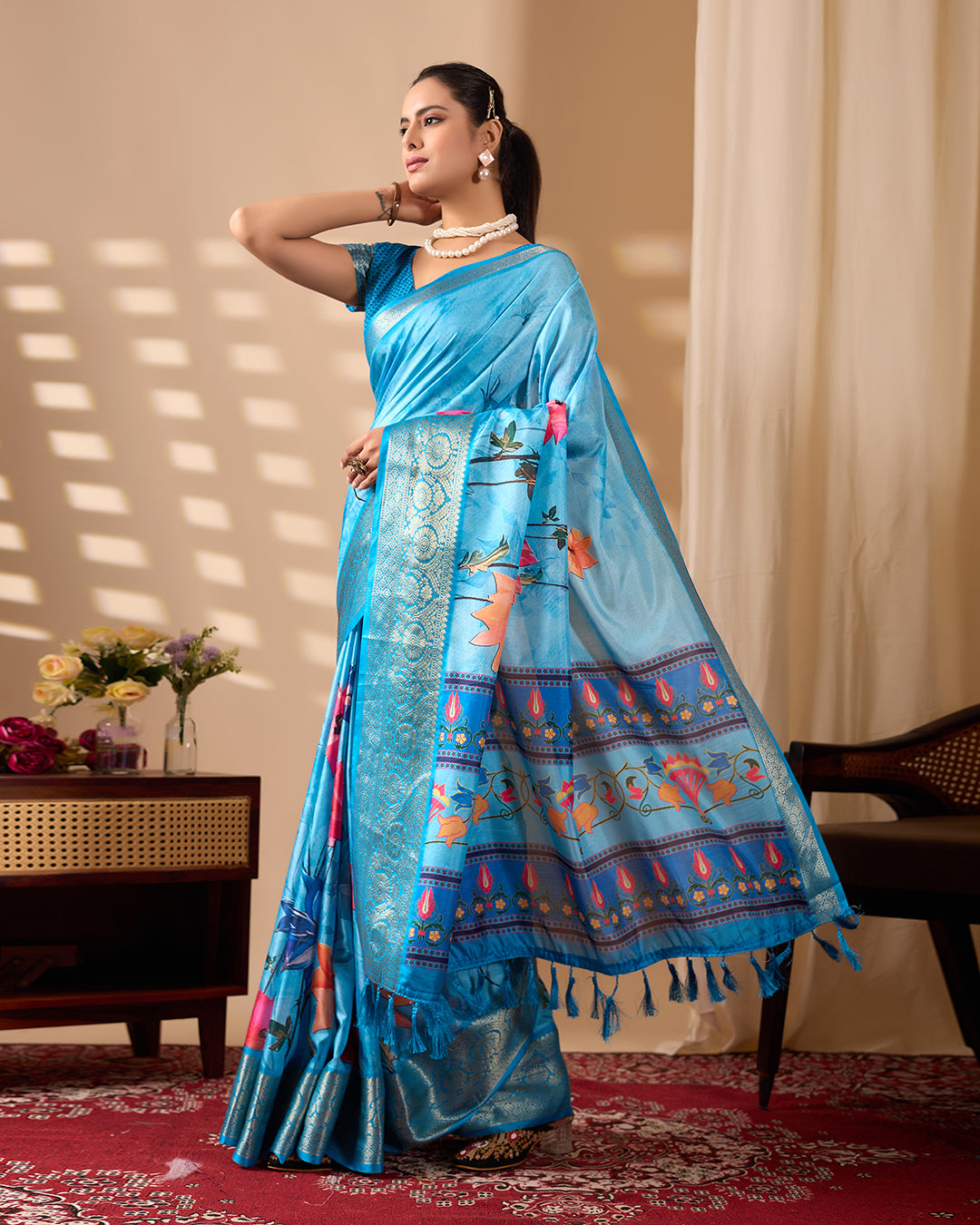 Soft Lichi Silk Saree in Serene Sky Blue Tone adorned with mesmerizing lotus-inspired digital prints and complemented by a luxurious golden zari woven border