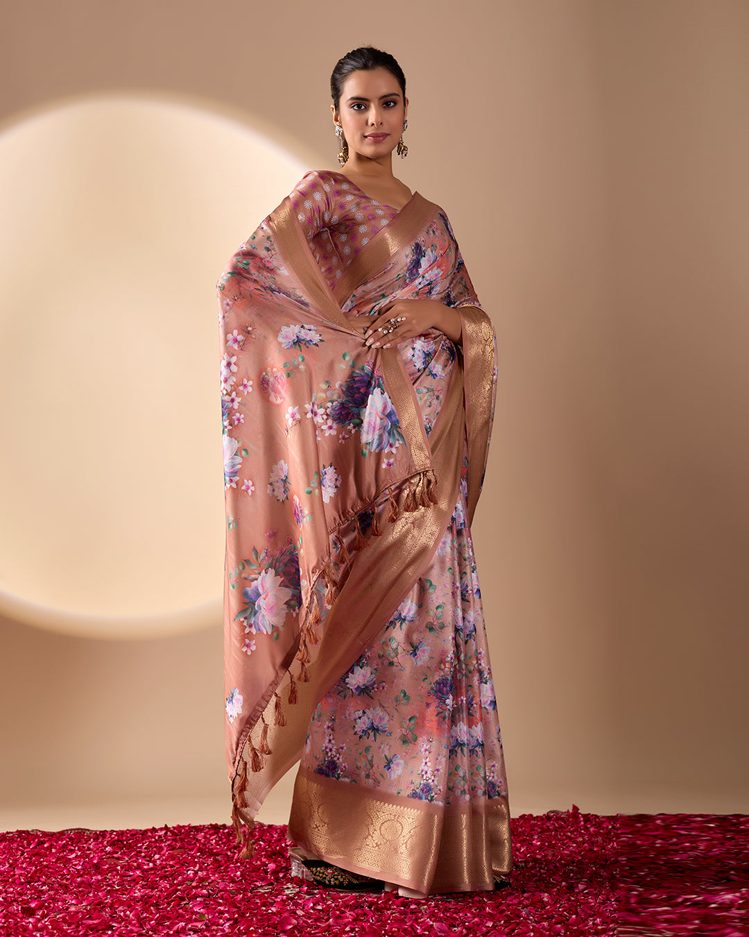 Soft Lichi Silk Saree in Rose Gold Shade enriched with elegant all-over floral digital prints and complemented by a luxurious woven zari border