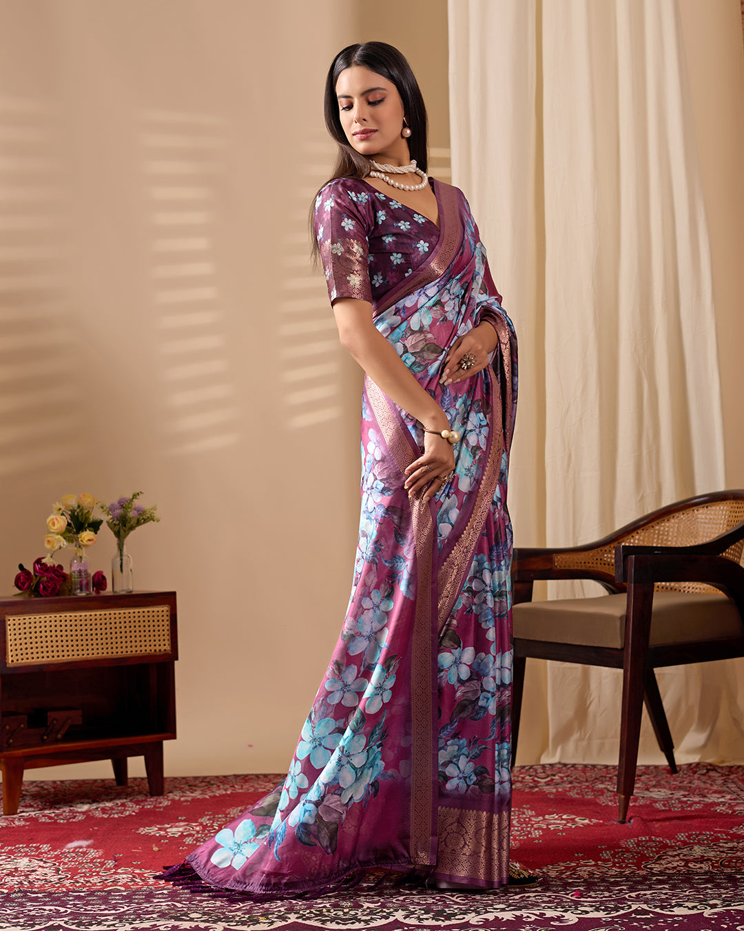 Soft Lichi Silk Saree beautifully enhanced with large blooming floral prints and a rich zari woven border