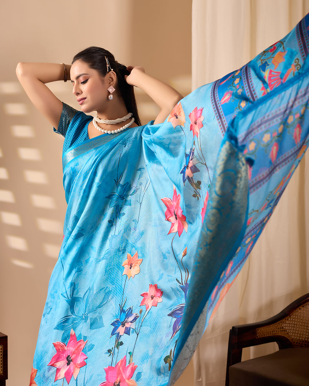 Soft Lichi Silk Saree in Serene Sky Blue Tone adorned with mesmerizing lotus-inspired digital prints and complemented by a luxurious golden zari woven border