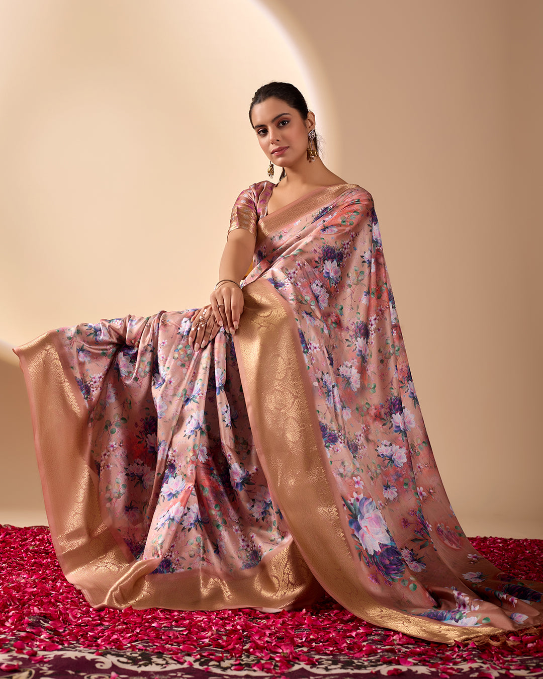 Soft Lichi Silk Saree in Rose Gold Shade enriched with elegant all-over floral digital prints and complemented by a luxurious woven zari border