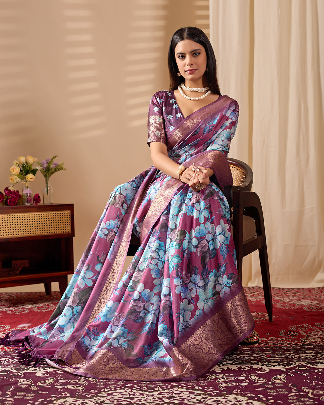 Soft Lichi Silk Saree beautifully enhanced with large blooming floral prints and a rich zari woven border