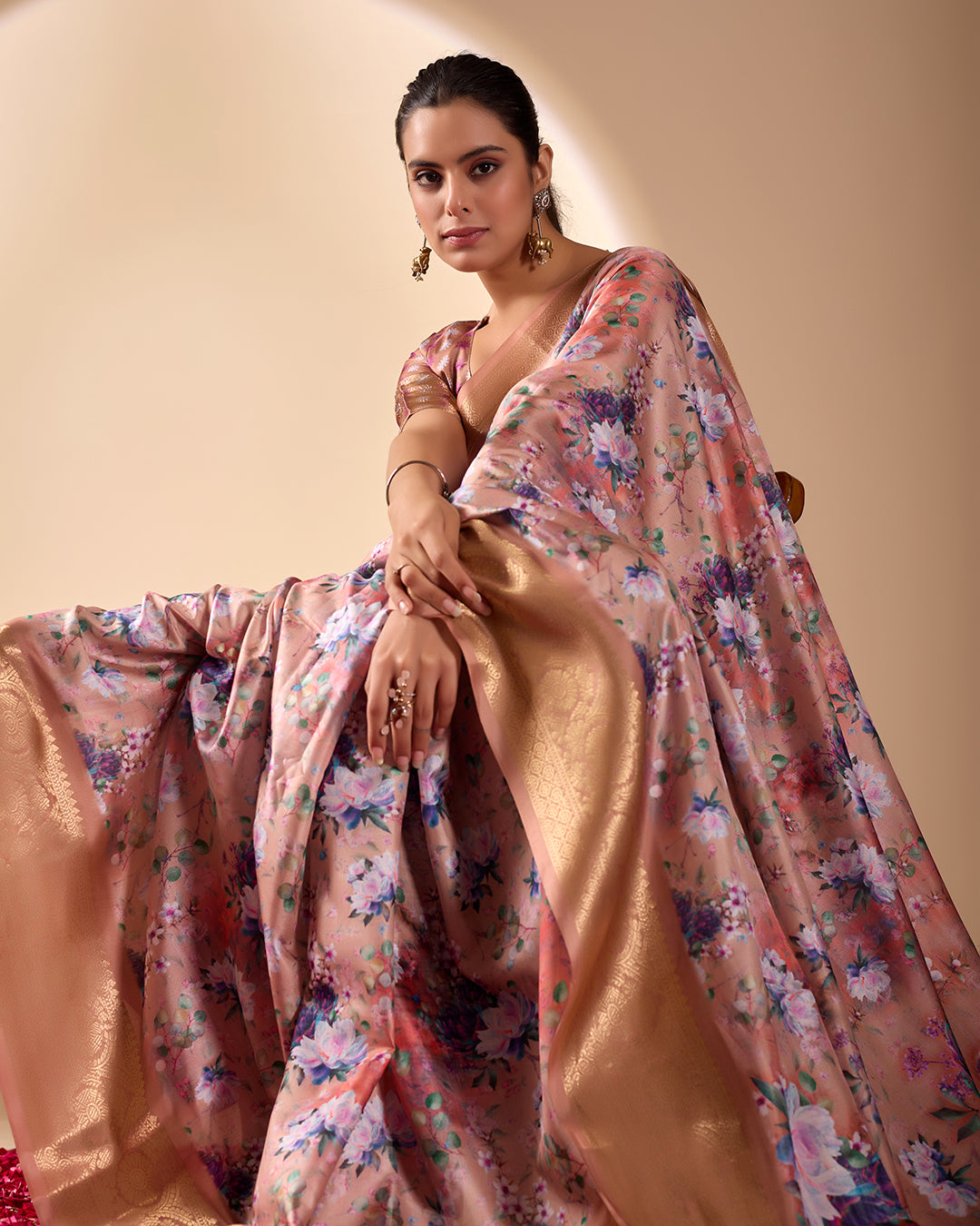 Soft Lichi Silk Saree in Rose Gold Shade enriched with elegant all-over floral digital prints and complemented by a luxurious woven zari border