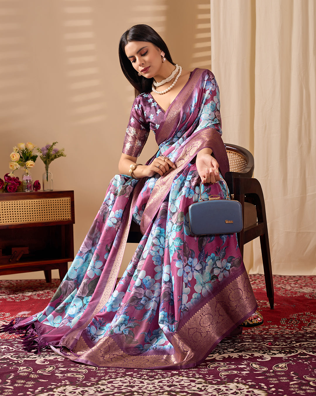 Soft Lichi Silk Saree beautifully enhanced with large blooming floral prints and a rich zari woven border