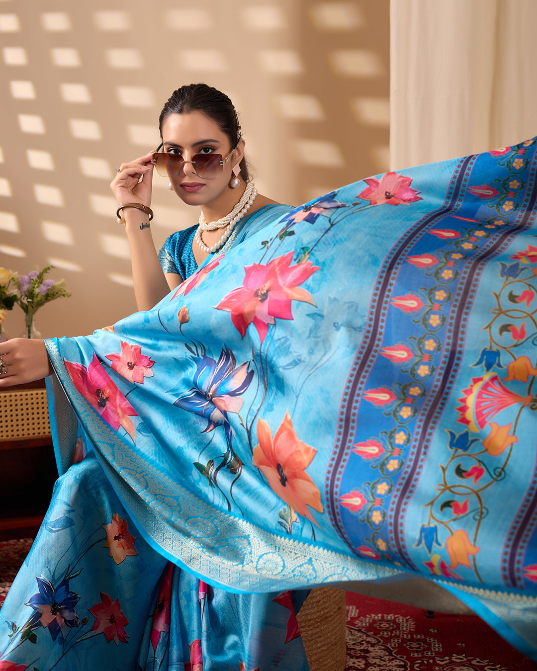 Soft Lichi Silk Saree in Serene Sky Blue Tone adorned with mesmerizing lotus-inspired digital prints and complemented by a luxurious golden zari woven border