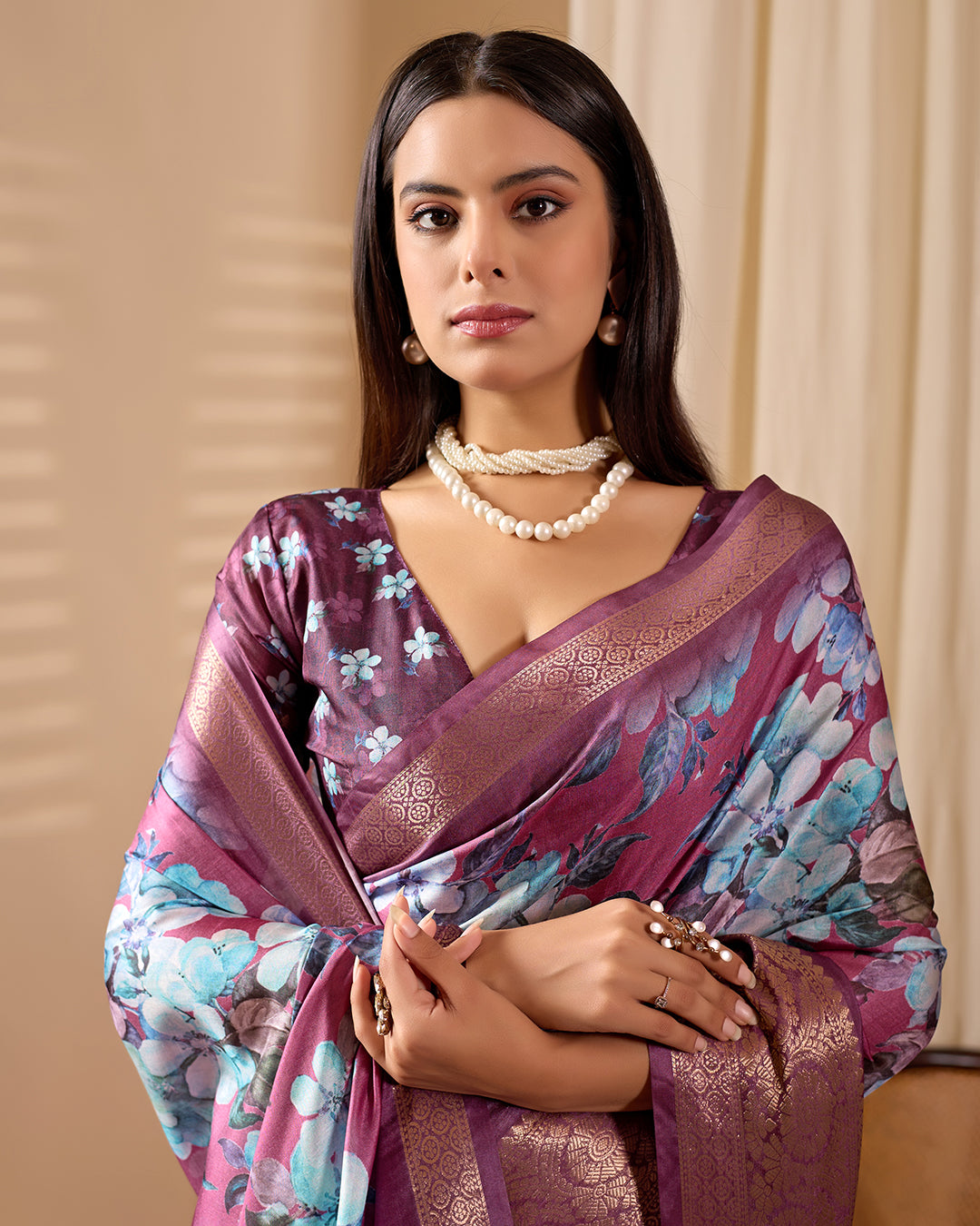 Soft Lichi Silk Saree beautifully enhanced with large blooming floral prints and a rich zari woven border