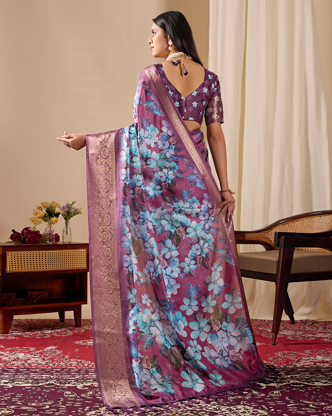 Soft Lichi Silk Saree beautifully enhanced with large blooming floral prints and a rich zari woven border