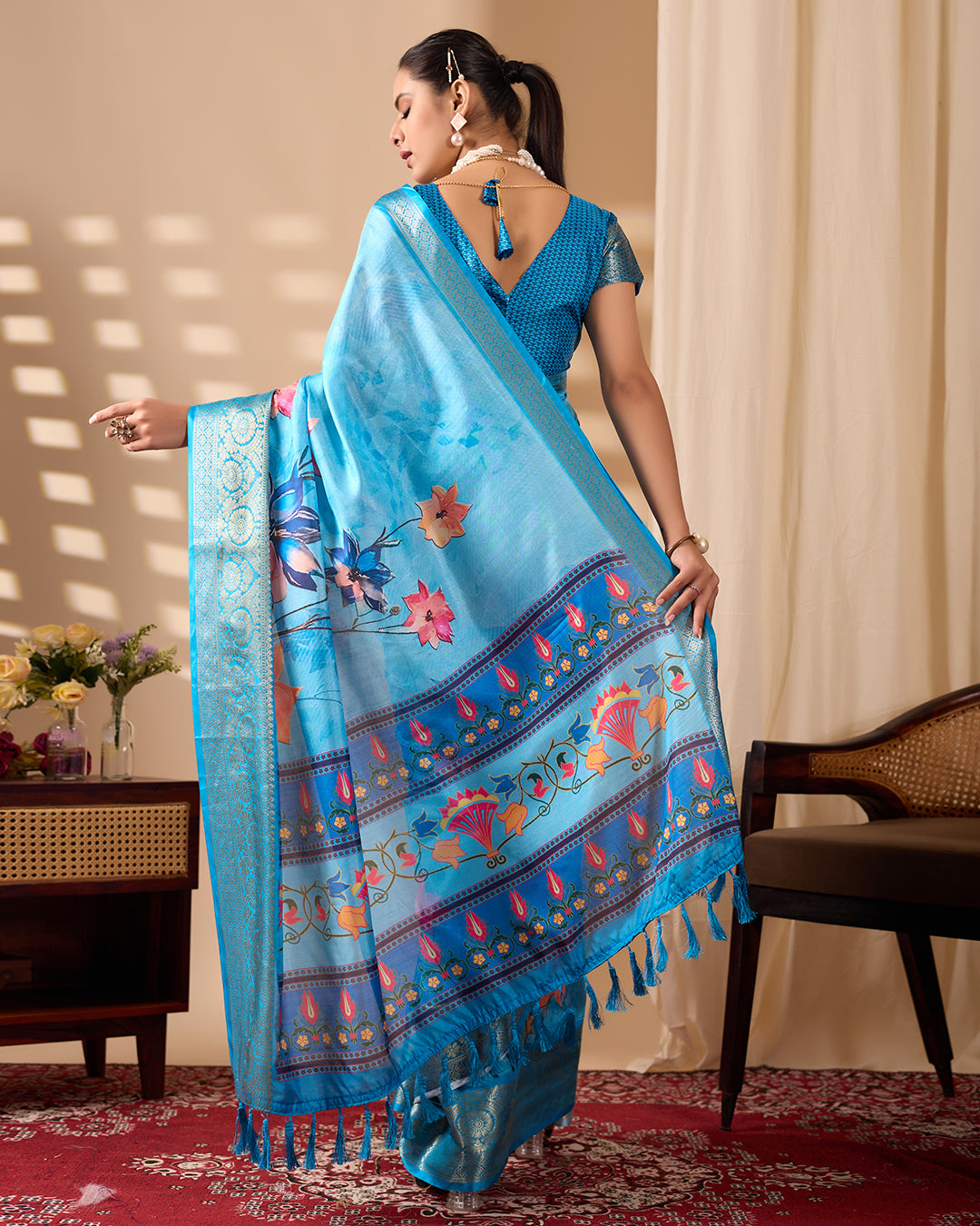 Soft Lichi Silk Saree in Serene Sky Blue Tone adorned with mesmerizing lotus-inspired digital prints and complemented by a luxurious golden zari woven border
