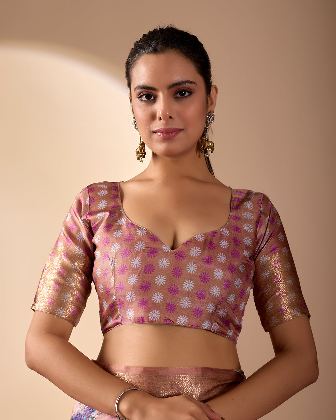 Soft Lichi Silk Saree in Rose Gold Shade enriched with elegant all-over floral digital prints and complemented by a luxurious woven zari border