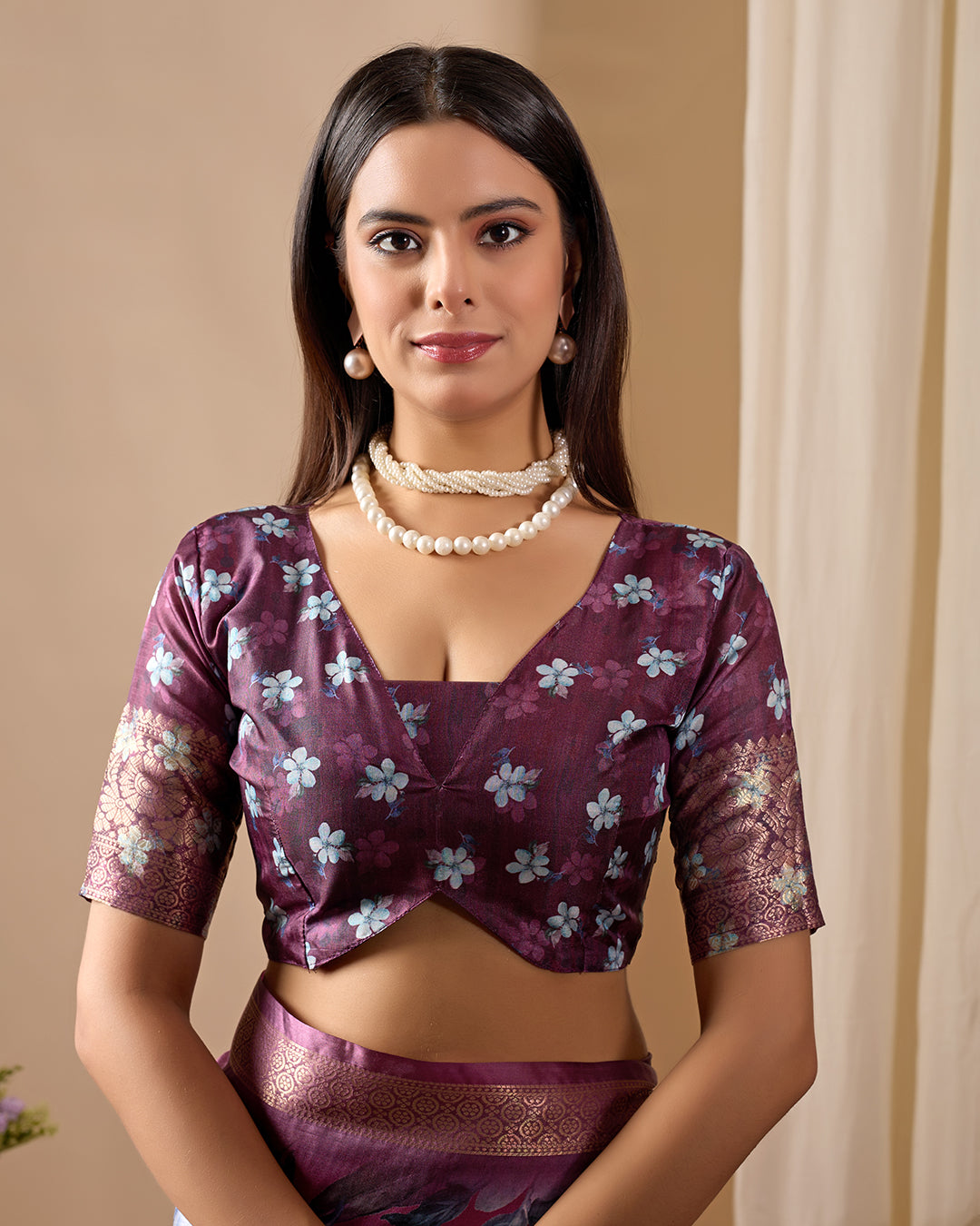 Soft Lichi Silk Saree beautifully enhanced with large blooming floral prints and a rich zari woven border