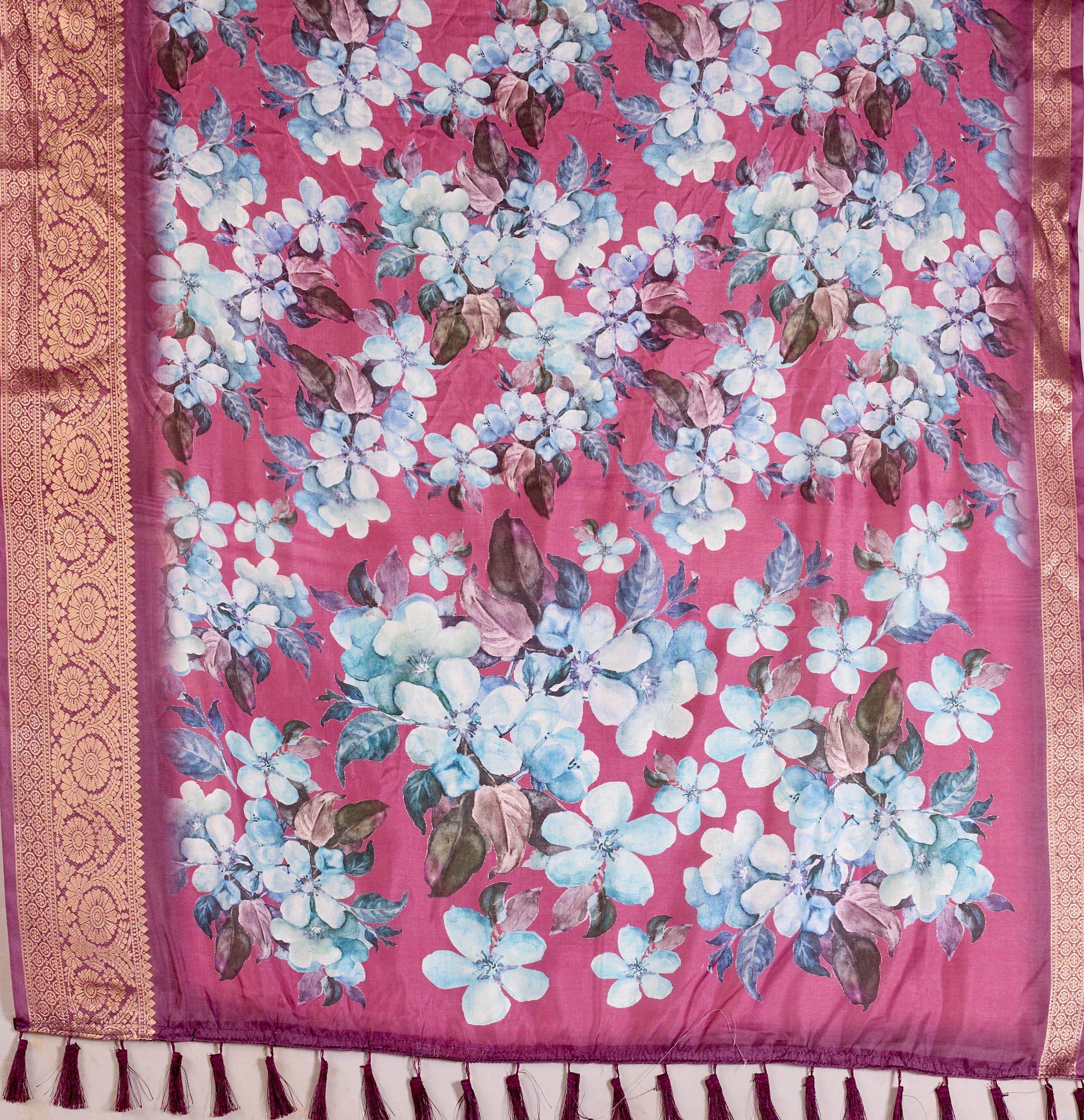 Soft Lichi Silk Saree beautifully enhanced with large blooming floral prints and a rich zari woven border