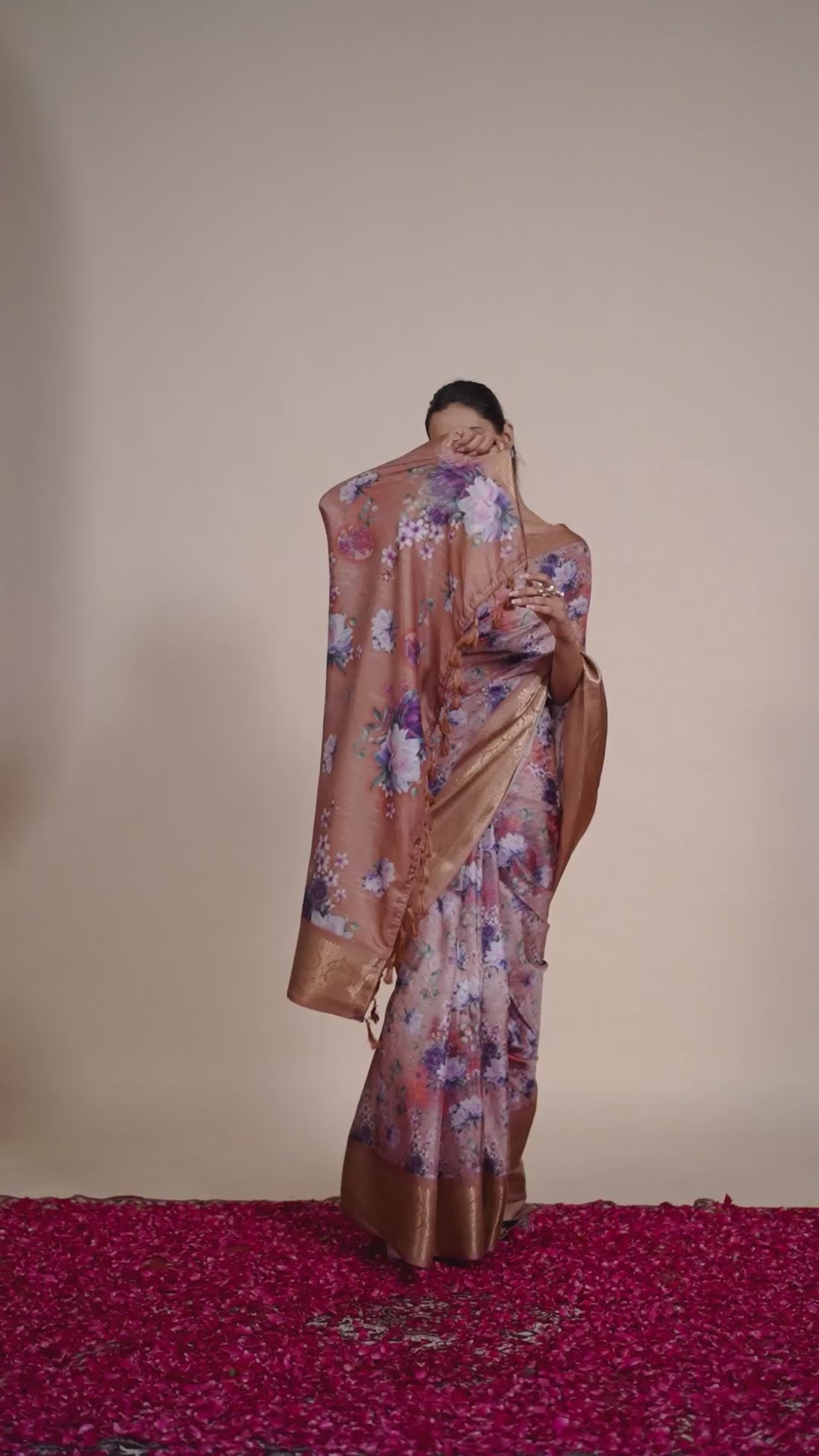 Soft Lichi Silk Saree in Rose Gold Shade enriched with elegant all-over floral digital prints and complemented by a luxurious woven zari border